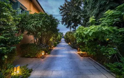 a long pathway lined with trees and lights at Yeng Keng Hotel in George Town
