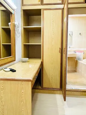 a bathroom with a wooden counter and a shower at Shuang Yang Sekinchan Homestay 7 in Sekincan