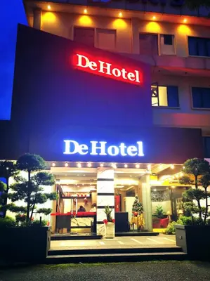 a hotel with a neon sign in front of it at De Hotel Ipoh in Ipoh