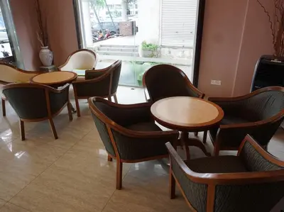 a restaurant with tables and chairs and a window at Hotel Seri Pauh in Perai