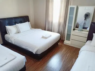 a hotel room with a bed and a mirror at Hotel Seri Pauh in Perai