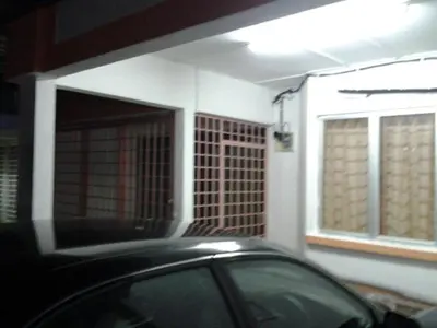 a black car parked in front of a house at Alisa Homestay in Sungkai
