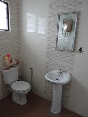 a bathroom with a toilet and a sink at Buntong Homestay -Rooms Only in Ipoh