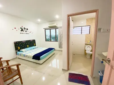 a bedroom with a bed and a toilet at Buntong Homestay -Rooms Only in Ipoh