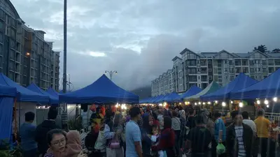 a crowd of people walking around a market with blue tents at My 4Rooms Apartment @ Golden Hills Pasar Malam in Cameron Highlands
