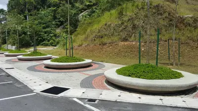 a parking lot with a bunch of bushes and trees at My 4Rooms Apartment @ Golden Hills Pasar Malam in Cameron Highlands