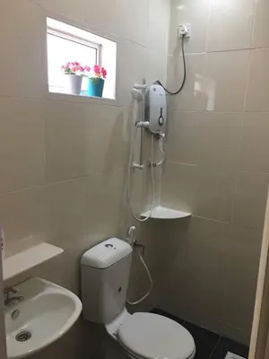 a bathroom with a toilet and a sink and a window at W9 atGoldenHills NightMarket WiFi 4R BBQ in Cameron Highlands