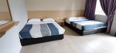a hotel room with two beds and a window at My Home N2 @ Golden Hills Night Market in Cameron Highlands