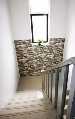 a stairway with a window and a plant on the wall at Sea Lion by the beach in George Town