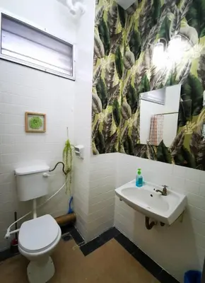 a bathroom with a toilet and a sink at Sea Lion by the beach in George Town