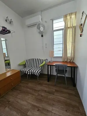 a room with a desk and a chair and a window at Sea Lion by the beach in George Town