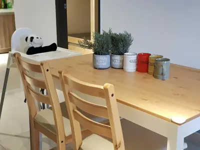a panda bear sitting on a chair at a table at Nordiska @ Majestic Ipoh in Ipoh