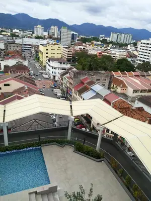 a view of a city with a pool and buildings at The Octagon Ipoh in Ipoh