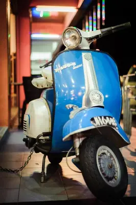 a blue and white scooter parked in a garage at Wan Alyasa Hotel in Cameron Highlands