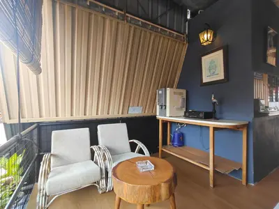 a living room with two chairs and a table at SECRET STUDIO On Factory in George Town