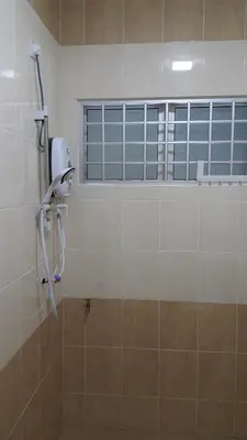a shower in a bathroom with a window at My STW Home 2 in Sitiawan