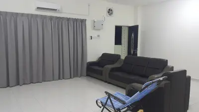 a waiting room with a couch and a chair at My STW Home 1 in Sitiawan