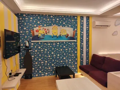 a living room with a couch and a wall at Iconic Suites & Pods Hotel in Ipoh