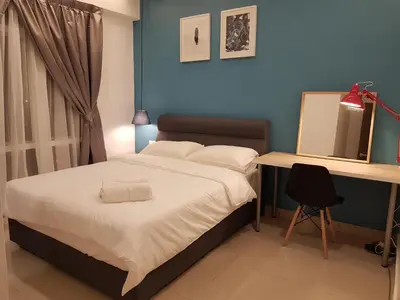 a bedroom with a bed and a desk and a mirror at Mike's Place @ The Majestic Ipoh in Ipoh