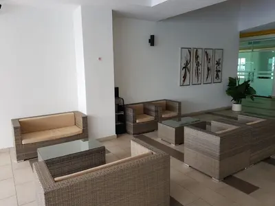 a lobby with wicker chairs and a glass table at Mike's Place @ The Majestic Ipoh in Ipoh