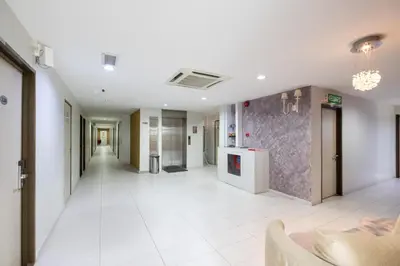 an empty hallway in a hospital with a room with a hallway at BG Business Hotel in Bukit Mertajam