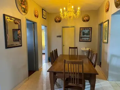 a dining room with a wooden table and chairs at Ar Rayyan Apartments Prima Villa 3D8 in Cameron Highlands