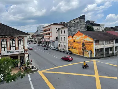 a city street with cars parked on the road at Barrack Street Hotel in Taiping