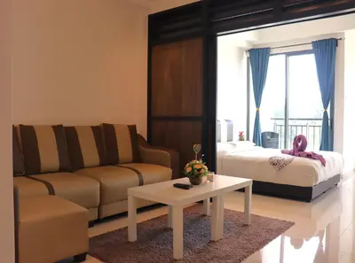 a living room with a couch and a bed at ATS Cameron Hotel & Apartments in Cameron Highlands