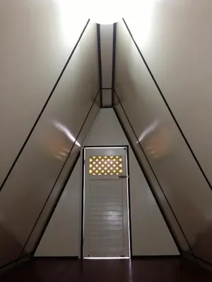 a room in a triangle with a light on top at Nipah Guesthouse Pangkor in Pangkor