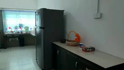 a kitchen with a green refrigerator and a window at Homestay Ahmad Kuala Kangsar in Kuala Kangsar