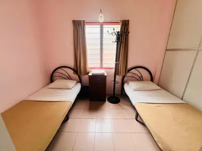 a room with two beds and a window at KRS Pines GuestHouse in Cameron Highlands