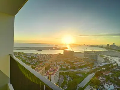 a view of the sunset from the balcony of a building at The Landmark Pulau Andaman Gurney Bay View in George Town