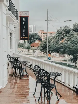 a row of black tables and chairs on a balcony at Wifi Boutique Hotel in George Town