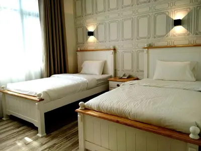 a bedroom with two beds and a window at Wifi Boutique Hotel in George Town