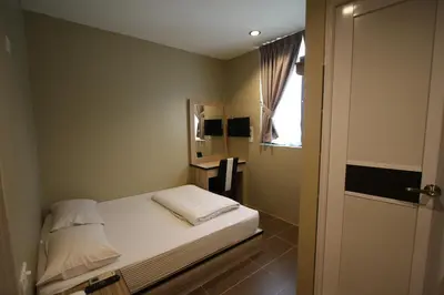a small bedroom with a bed and a window at Shamrock Greenhill in Ipoh
