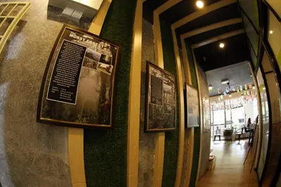 a wall with two framed pictures on it at Sleepbox Hotel in Cameron Highlands