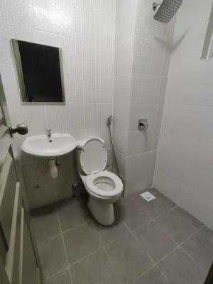a bathroom with a toilet and a sink at Family Apartment at The Quintet Cameron Highlands in Cameron Highlands