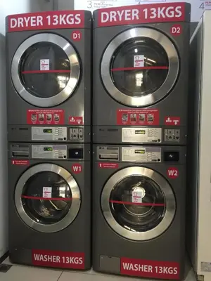 three washing machines are sitting next to each other at Ixora Hotel Penang in Perai