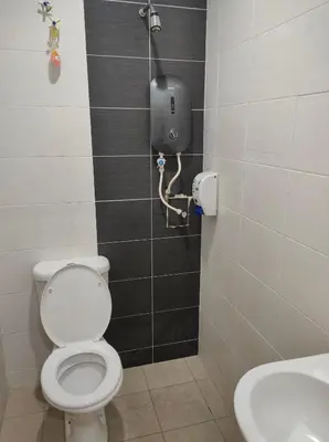 a bathroom with a toilet and a sink at Hotel Star Inn in Teluk Intan