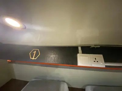a bathroom with a toilet and a black wall at Hikers Sleep Port Guesthouse in Cameron Highlands
