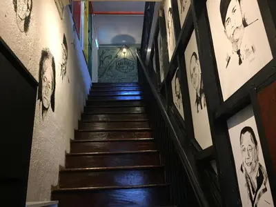 a staircase in a building with graffiti on the walls at Hikers Sleep Port Guesthouse in Cameron Highlands
