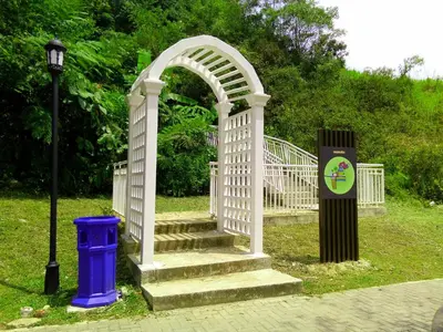 a white arch with stairs and a blue trash can at Golden Hill 3 Room Apt @ Night Market in Cameron Highlands