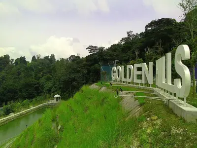 a large sign that reads columbias on the side of a river at Golden Hill 3 Room Apt @ Night Market in Cameron Highlands