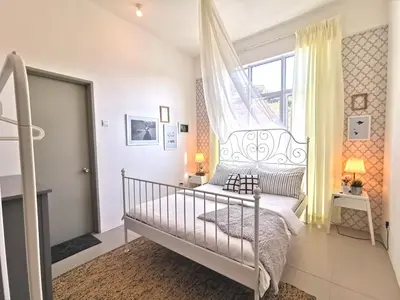 a white bedroom with a bed and a window at Barington Square near Night Market in Cameron Highlands