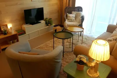 a living room with a couch and chairs and a television at Barington Square near Night Market in Cameron Highlands