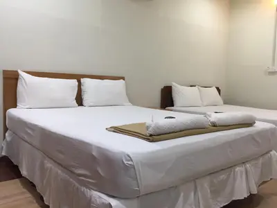 a bedroom with two beds with white sheets and pillows at Hotel Sri Malim in Tanjung Malim