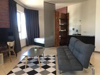 a living room with a couch and a table at PM Octagon Ipoh Suites & Apartment 3 in Ipoh
