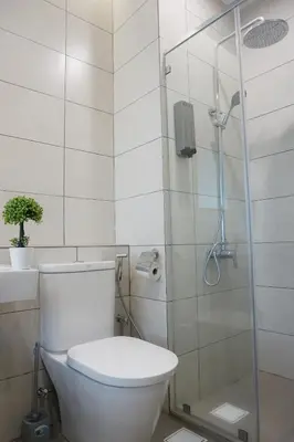 a bathroom with a toilet and a glass shower at PM Octagon Ipoh Suites & Apartment 3 in Ipoh
