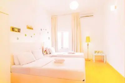 a white room with a white couch and a window at Chulia Heritage Hotel in George Town