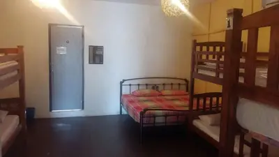 a room with a bunk bed and a door to a room with a bunk bed at Cocoa Mews Cafe and Homestay in George Town